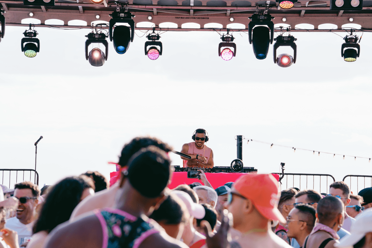 Man DJing music to a crowd at The Pink Party
